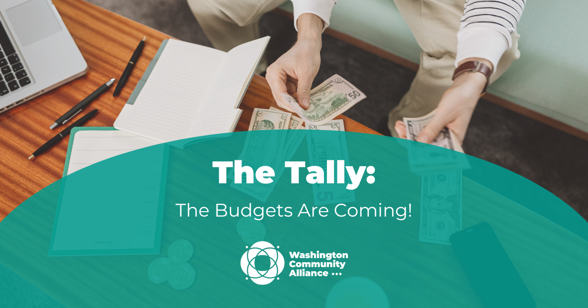A stock photo of a white person at a table with a computer, pens, paper, and cash in front of them. A green semi-circle is overlayed with white text that reads "The Tally: The Budgets Are Coming!" and includes the WCA logo.