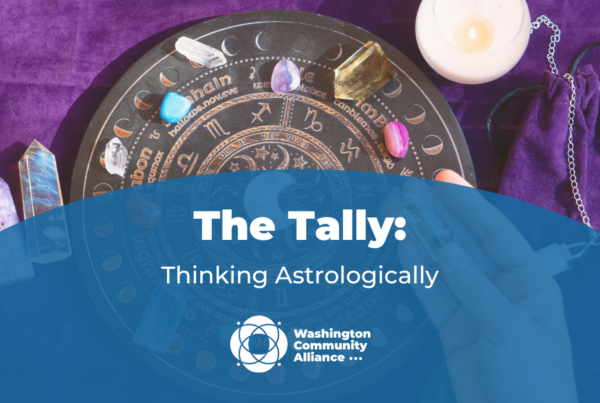 Graphic for The Tally blog titled "Thinking Astrologically" with a photo of an astrological tool and crystals in the background.