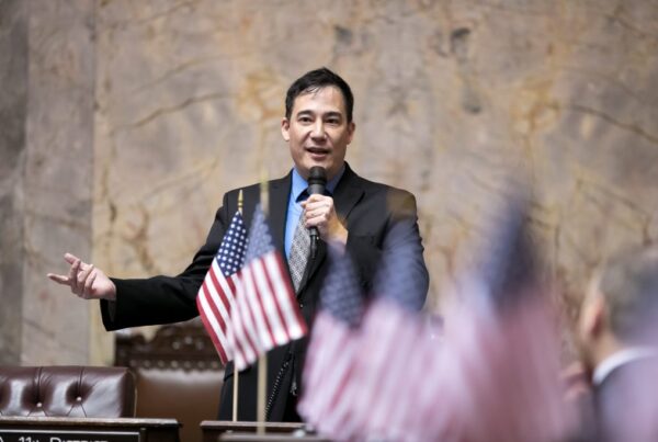 Photo of Secretary of State Steve Hobbs speaking on the floor of the Washington State Senate.