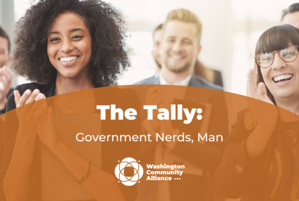 Graphic for The Tally blog titled "Government Nerds, Man" with a stock photo of people clapping and smiling in the background.